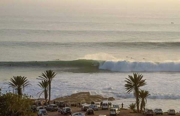Sunset over Anchor Point, Taghazout, Morocco, with surfers in action